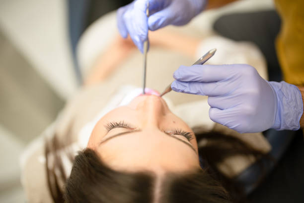 istock Dentist working with tools on female patient's mouth 1447630111