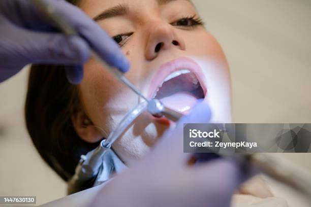 Dentist Working With Tools On Female Patients Mouth Stock Photo - Download Image Now