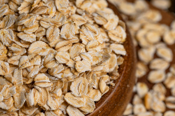 istock Oat flakes poured into a wooden bowl 1447630466