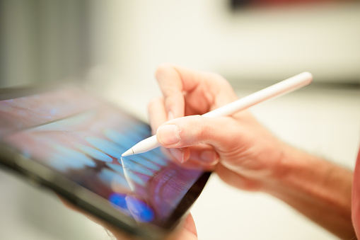 Orthodontist working on digital tablet with pen