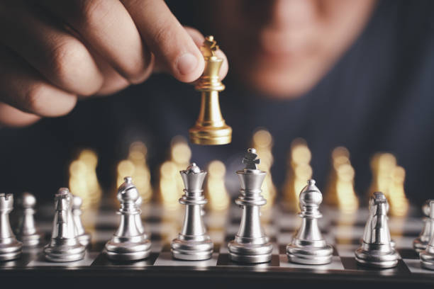 istock Businessman moving chess piece on chess board game concept for ideas and competition and strategy, business success concept, business competition planing teamwork strategic concept. 1447631430