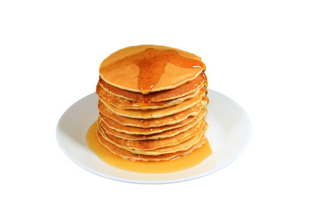istock Plate of mouthwatering pancakes stack with maple syrup Isolated on White Background 1447632848
