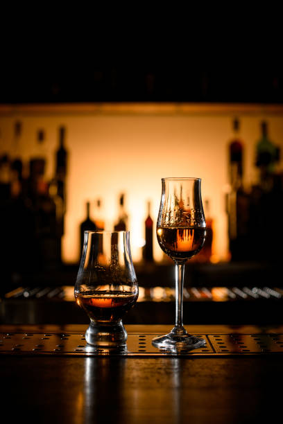 istock stemware and glass with alcoholic drinks on bar counter. 1447634879