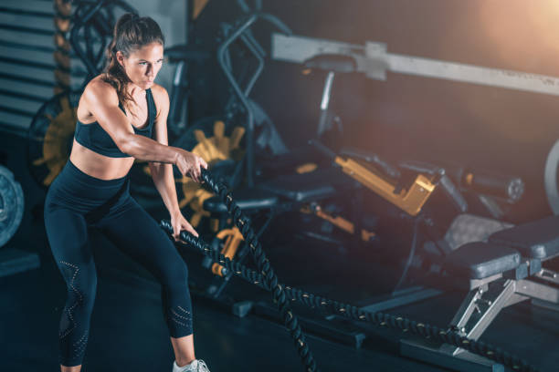 istock Agility training, woman exercising with rope in a gym. 1447635853