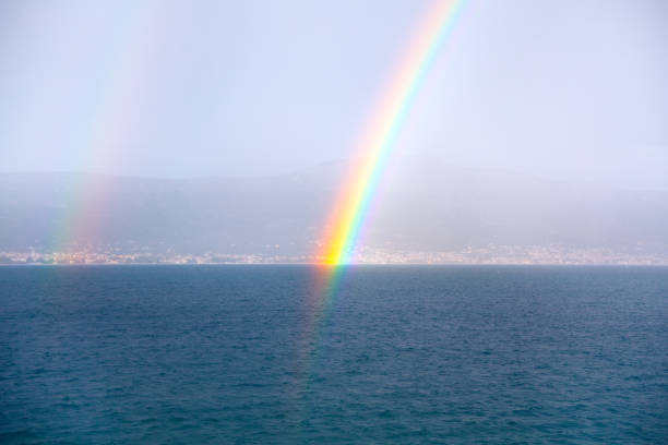 Real rainbow over the sea . Natural phenomenon with spectrum of colors