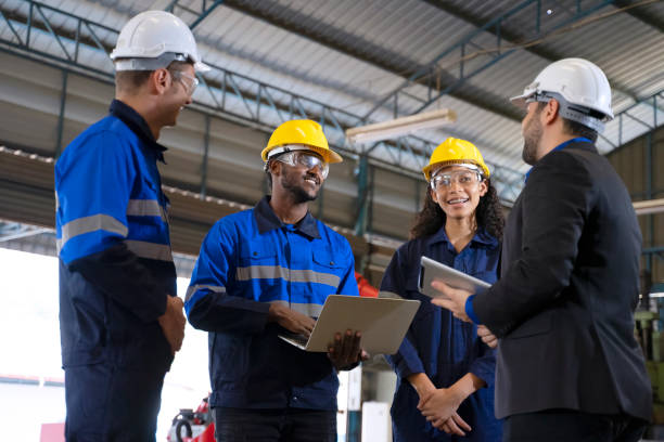 istock Employees are working at factory with robotic arms. 1447637381