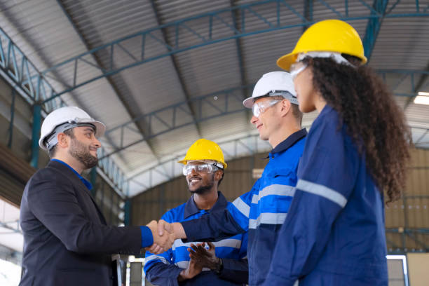 istock Employees are working at factory with robotic arms. 1447637390
