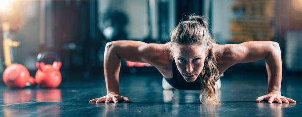 istock Woman Doing Push-ups in the gym. Strength Training. 1447639619