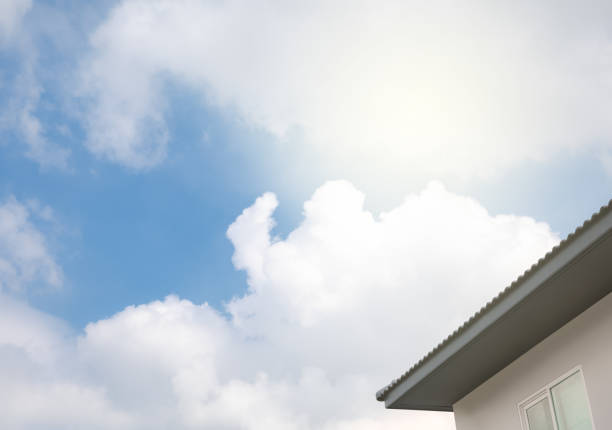 part of house roof and cloudy sky