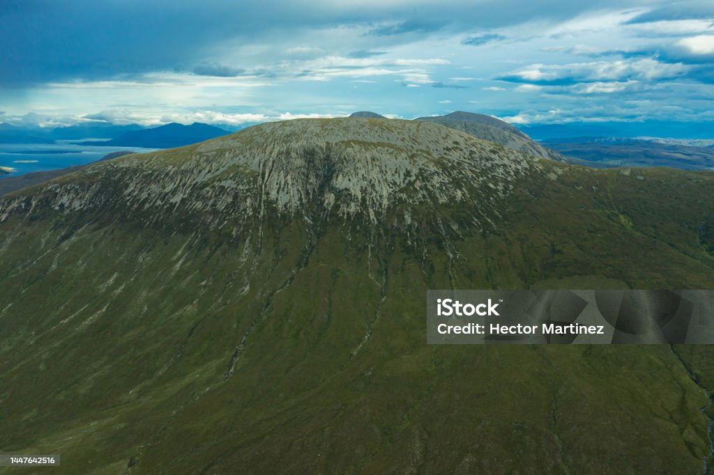 Mountain ranges on the isle of Skye Mountain ranges on the isle of Skye in Scotland with cloudy blue sky in view. Backgrounds Stock Photo