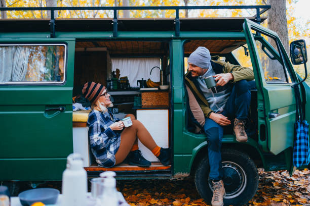 istock Couple Sitting in the Van and Drinking Coffee 1447643077