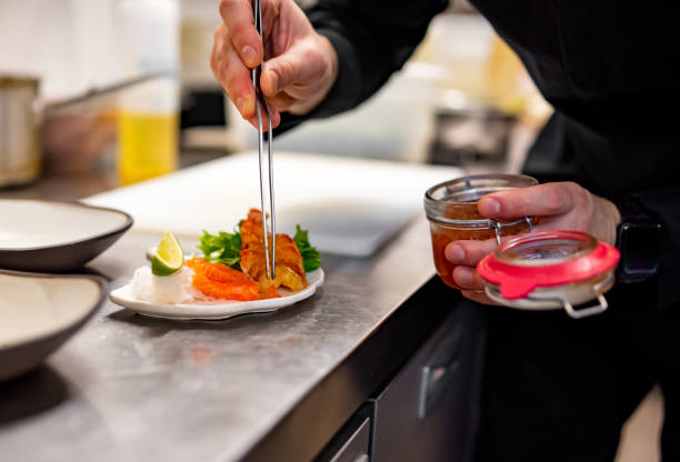 istock chef cooking slice salmon fish and shrimp with salad on kitchen 1447643088