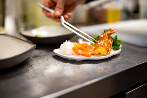 istock chef cooking slice salmon fish and shrimp with salad on kitchen 1447643102