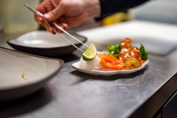 istock chef cooking slice salmon fish and shrimp with salad on kitchen 1447643130