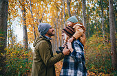 Lovely Family of Three on a Walk in the Forest in Autumn