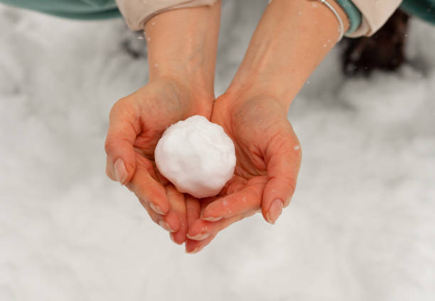 istock Uneven snow in hands without gloves 1447646834