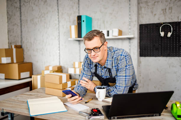 istock Successful small business owner using smartphone 1447650681