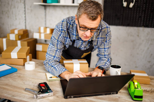 istock Busy man works on laptop in his online store 1447650764