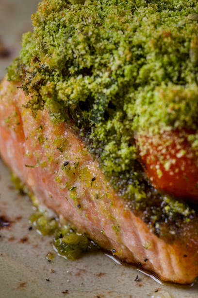 istock Fried salmon steak with cherry tomatoes, green sprinkles on a round plate. Vertical orientation 1447652131