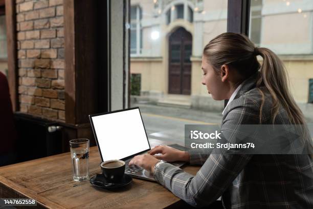 Young Business Person Owner Of Restaurant Or Cafeteria Bar Calculating Year Tax And Profit Earnings On The Laptop Freelancer Working In The Coffee Shop On New Project Stock Photo - Download Image Now