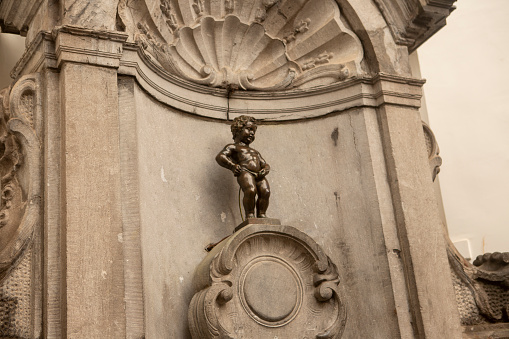 Historical Manneken piss ornamental decorative sculpture fountain at street of brussells belgium