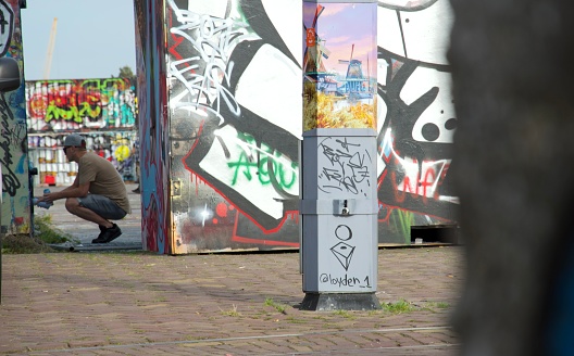 Graffiti artist at work in Amsterdam Noord
