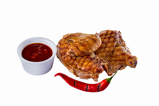 Grilled chicken half with red hot pepper and red sauce. On a white background. Horizontal orientation