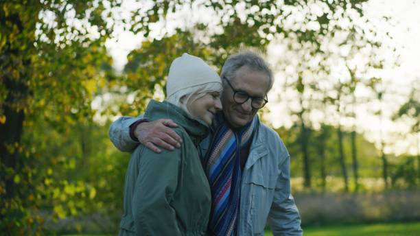istock Loving elderly couple walking down the park embracing 1447659702