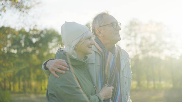 istock Happy loving elderly couple walking down the park 1447659710