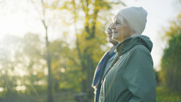 istock Loving elderly couple walking down the park 1447659733