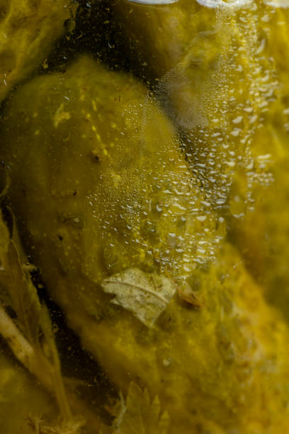 istock Pickled cucumbers in a glass jar with condensation drops 1447660731