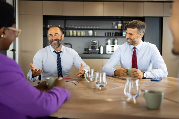 istock Happy business team talking on a break in cafeteria. 1447664438