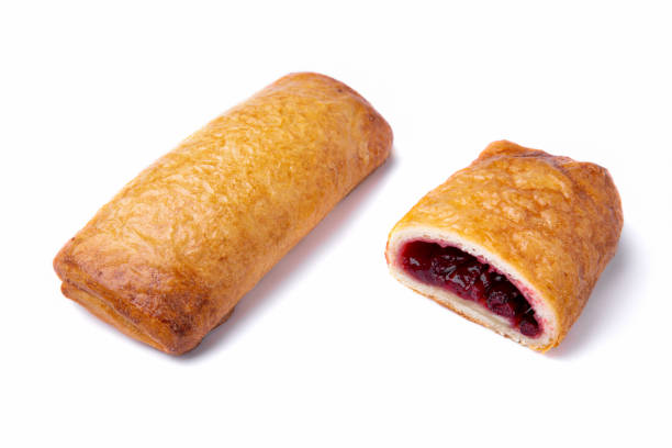 istock Bun with cherry jam on a white plate, close-up. Whole and sectional filling. Horizontal orientation 1447665539