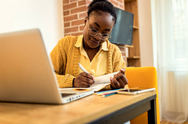 istock Young African American female student studying at home. 1447665811