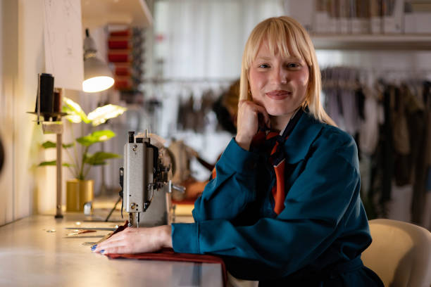 istock Smiling tailor working in clothing design studio. 1447666160