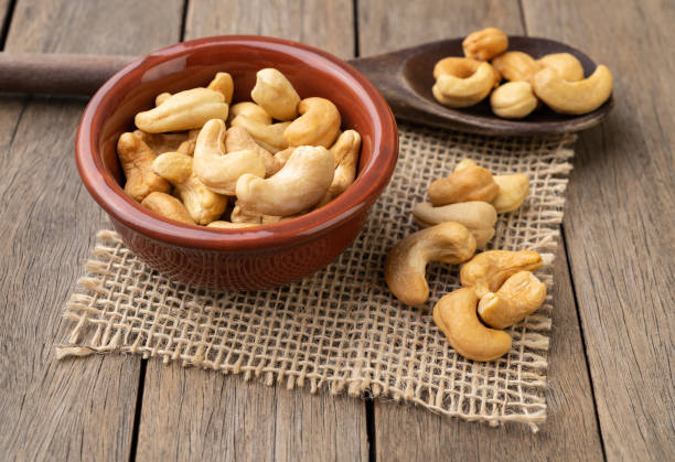 istock Cashew nuts in a bowl over wooden table 1447668387
