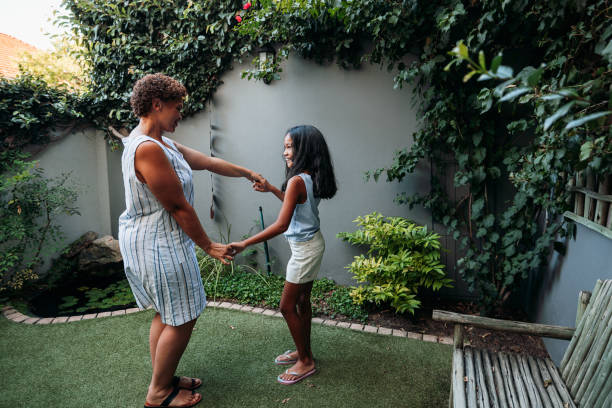 istock Granny and granddaughter dancing together at backyard 1447669052