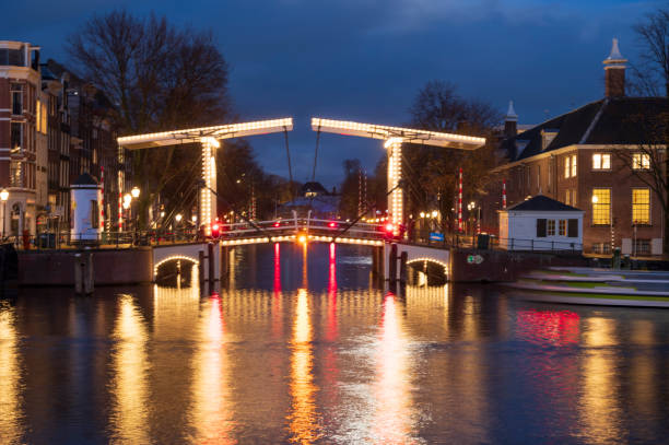 istock Amsterdam illuminated bridges at the Amstel river during winter 1447670270