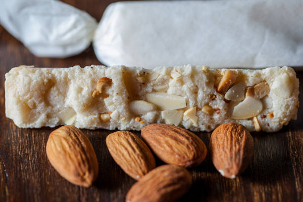 istock Pastries with whole and crushed almonds on a wooden background. Horizontal orientation 1447672273