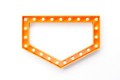 Light bulbs forming an orange arrow shaped frame on white background. Horizontal composition with clipping path and copy space.