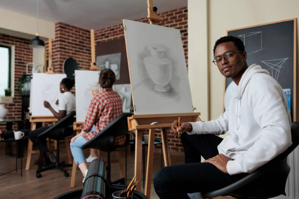 istock Portrait of painter student attending art class working at creative artwork 1447673582