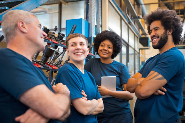 istock Team of workers during break in factory 1447673663