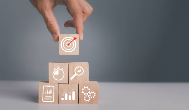 istock business strategy, Action plan, Goal and target, hand stack woods block step on table with icon about business strategy and Action plan. business development concept. 1447674024