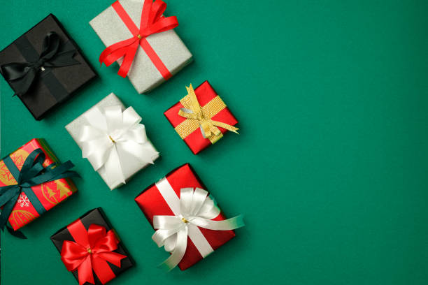 istock gift box background, gift box top view, Many boxes are on the green background. Anniversary day, Celebration day, Graduation day. 1447679324