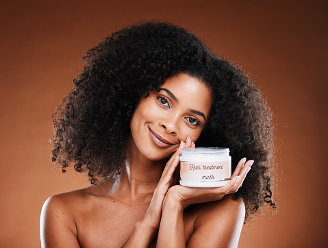 Beauty, luxury hair care mask and black woman conditioner in jar, organic moisturizer for afro hairstyle. Health, wellness and portrait of woman marketing haircare treatment in studio background.