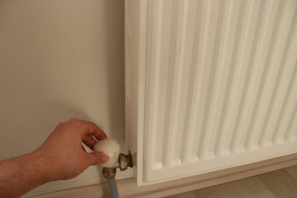 istock hand of man regulating natural gas temperature. 1447683581