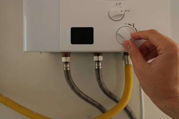 istock hand of man regulating natural gas temperature. 1447683608