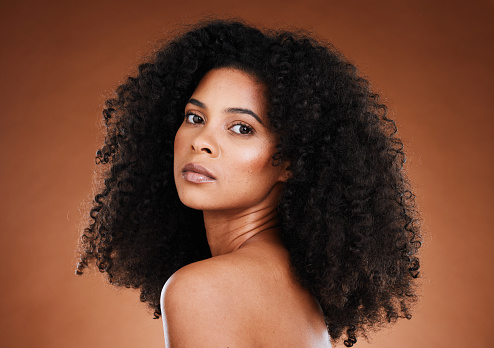 Model, black woman and afro hair with beauty, makeup and wellness in aesthetic portrait for cosmetic self care. Woman, hair care and cosmetics face with natural curly hair against studio background