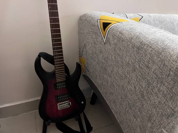 Guitar places beside a sofa