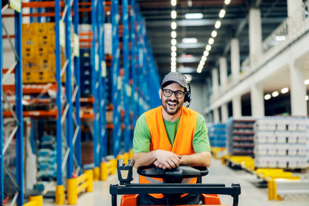 istock A storage worker posing on forklift and smiling at the camera. 1447687241